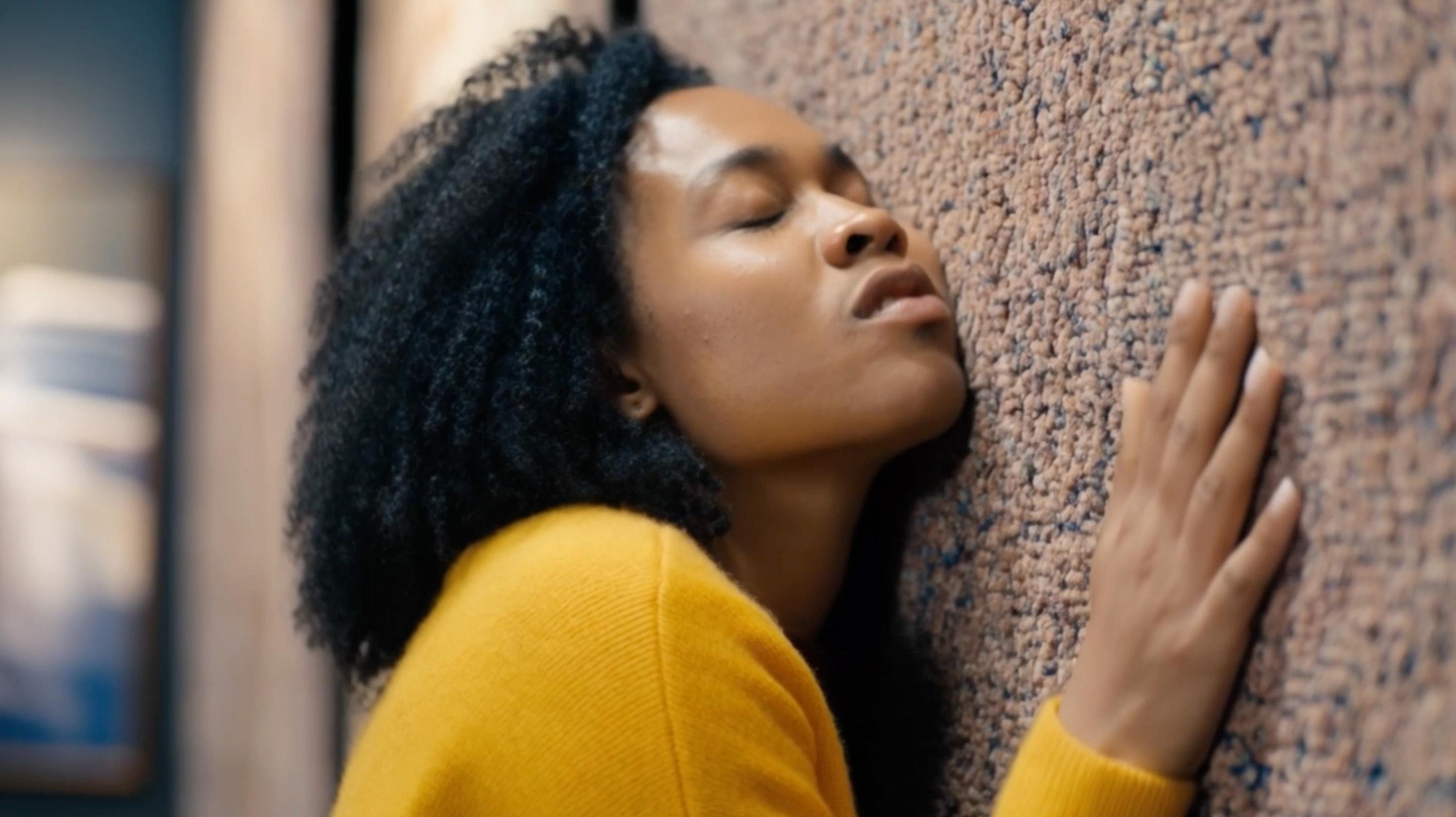 Woman feeling textured rug
